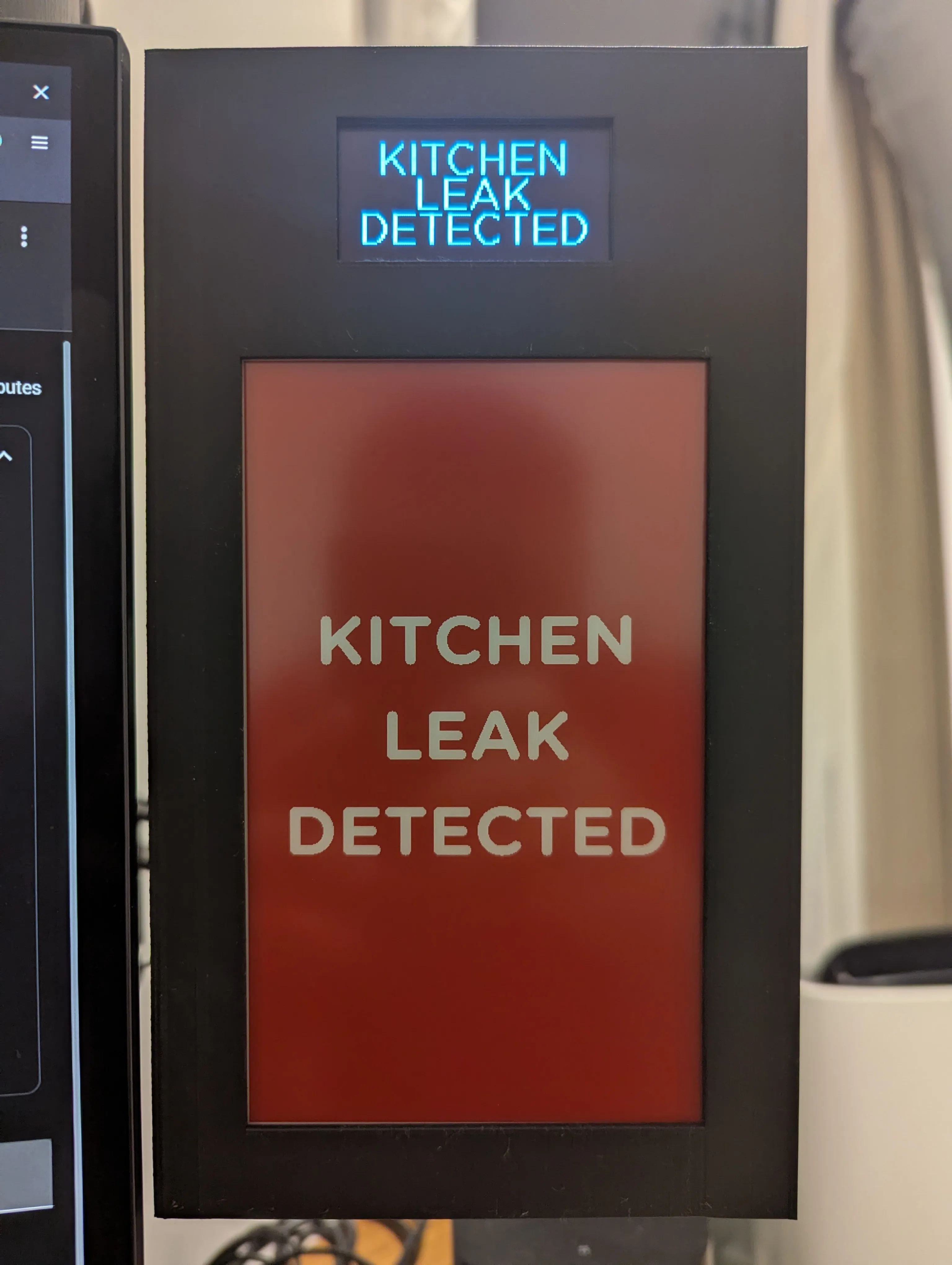 Photograph of the display showing a kitchen leak detected